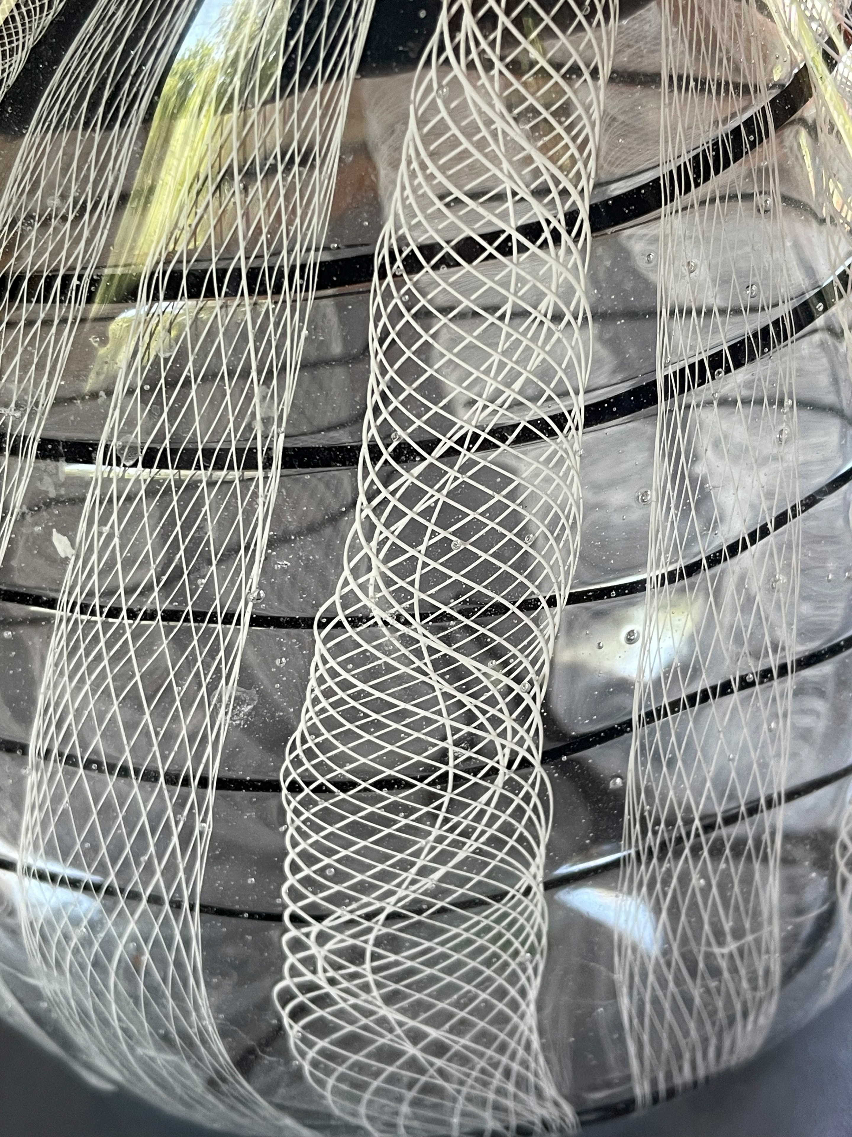 Close-up detail of black and white reticello glass sphere