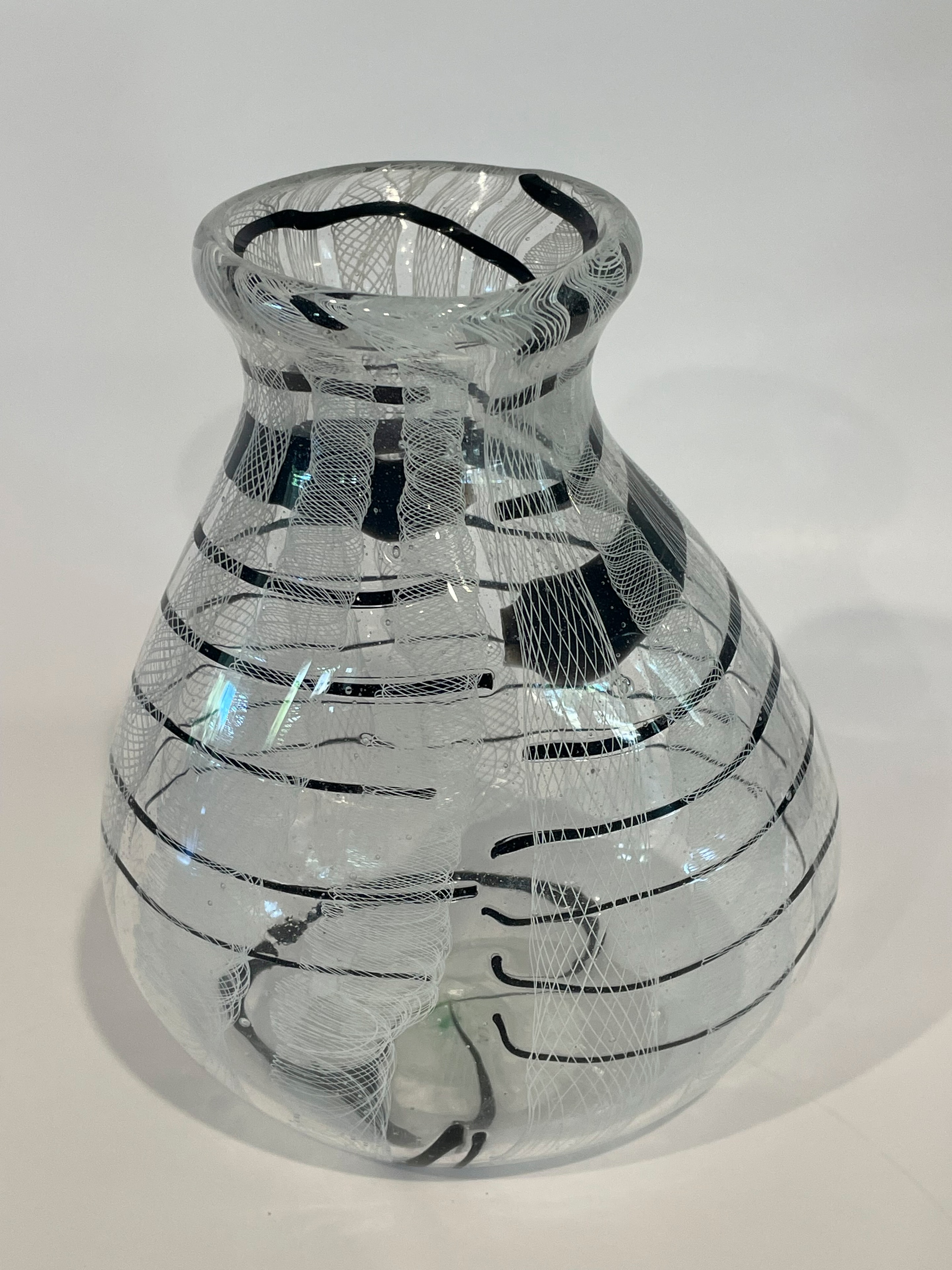 Clear blown glass vase with black and white latticino cane pattern