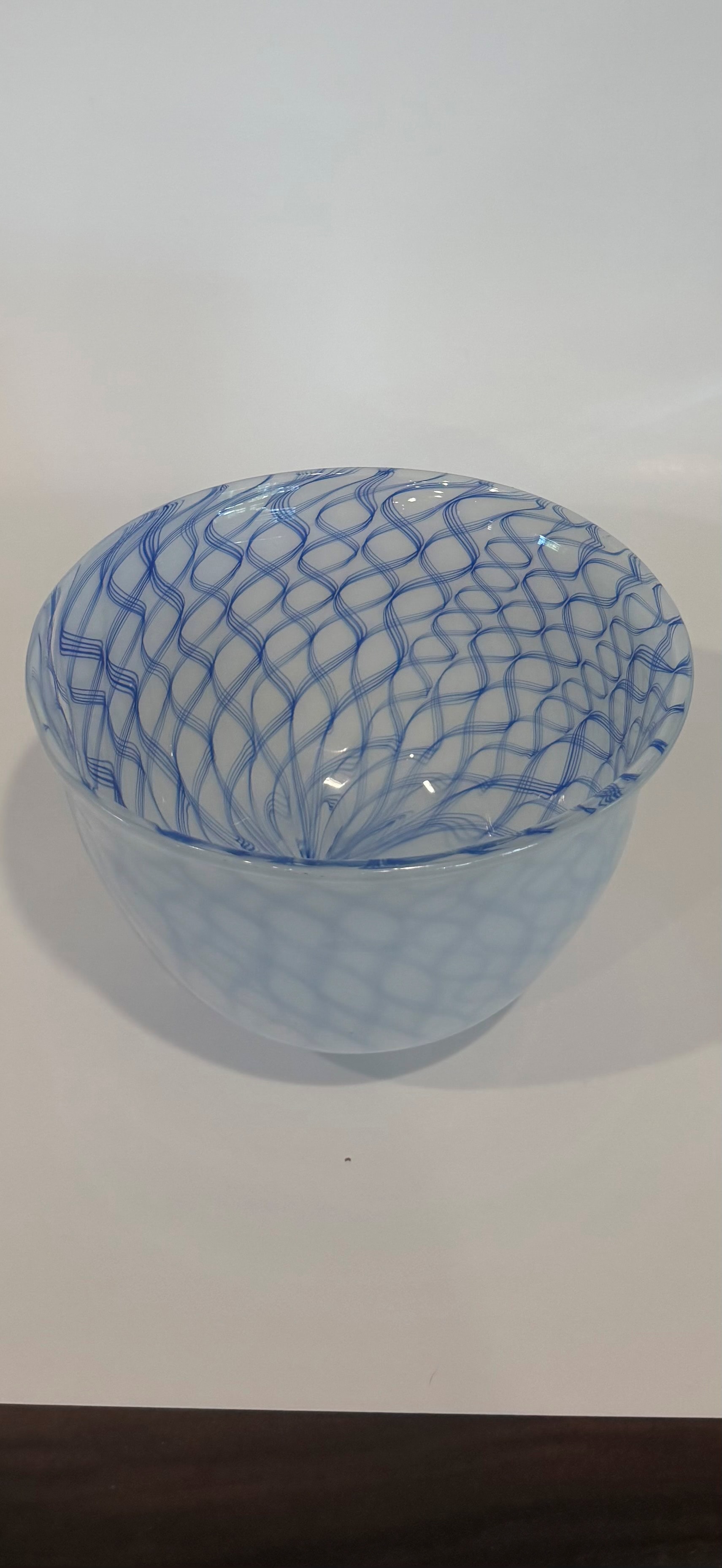 White blown glass bowl with blue gingham cane lattice pattern
