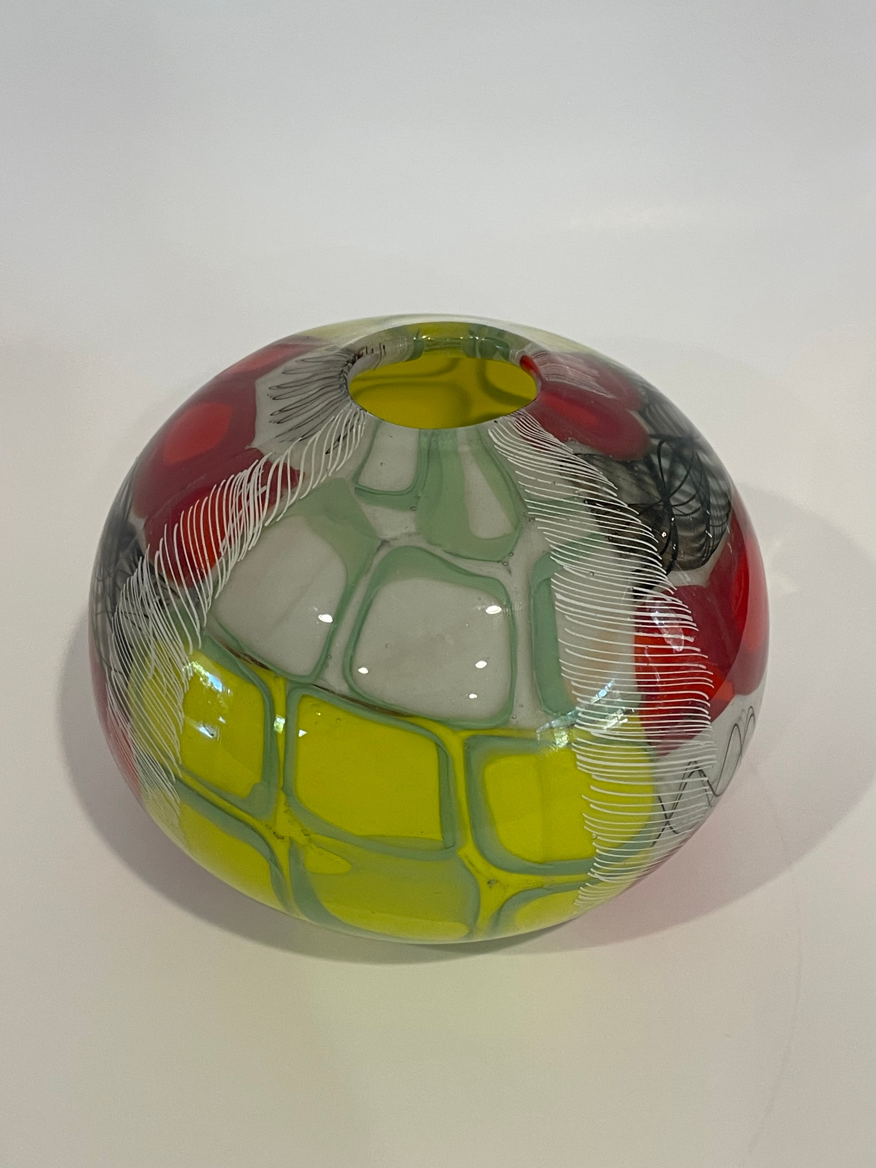 Multicolor murrine glass sphere with red yellow and green pattern