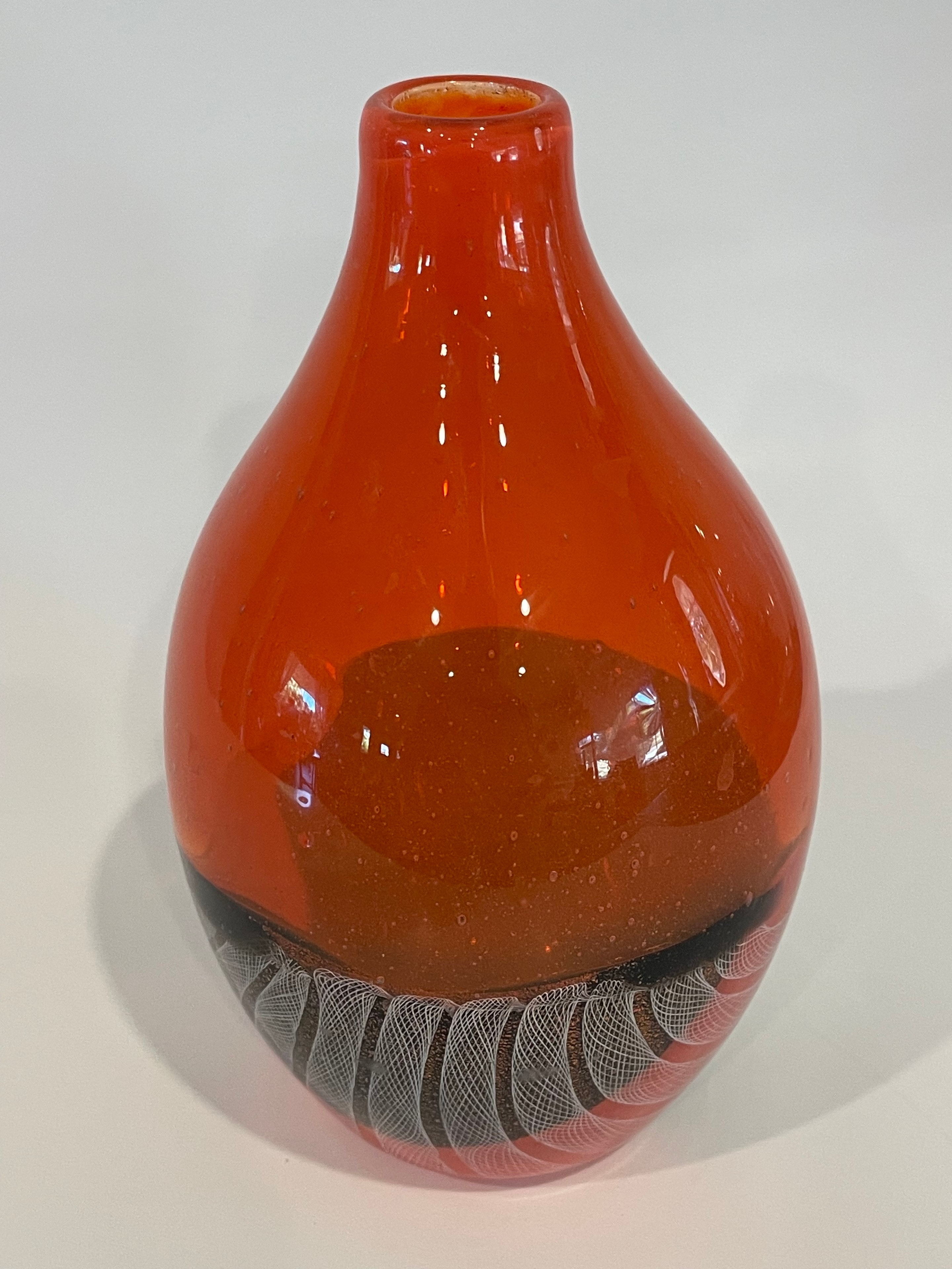 Red blown glass vessel with white cane detail