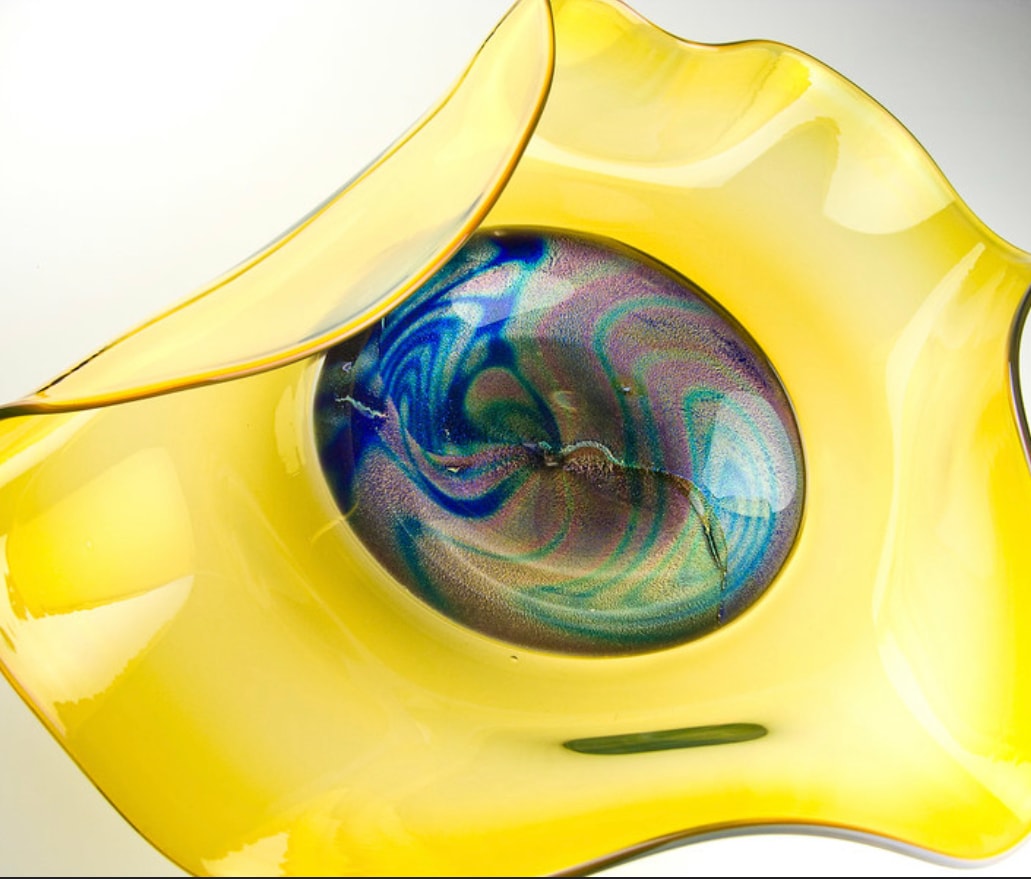 Yellow glass bowl with blue iridescent center